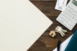 A house key resting on legal documents, symbolizing the Stamp Duty component of UK property tax upon purchase.